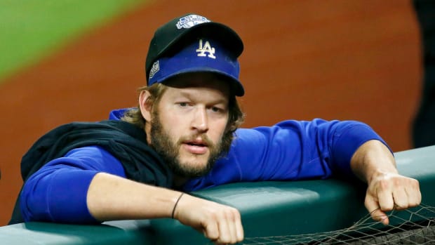 Oct 8, 2020; Arlington, Texas, USA; Los Angeles Dodgers starting pitcher Clayton Kershaw (22) wears an NLDS hat over his team hat after their win over the San Diego Padres after game three of the 2020 NLDS at Globe Life Field. The Los Angeles Dodgers won 12-3 to sweep the San Diego Padres. Mandatory Credit: Tim Heitman-USA TODAY Sports